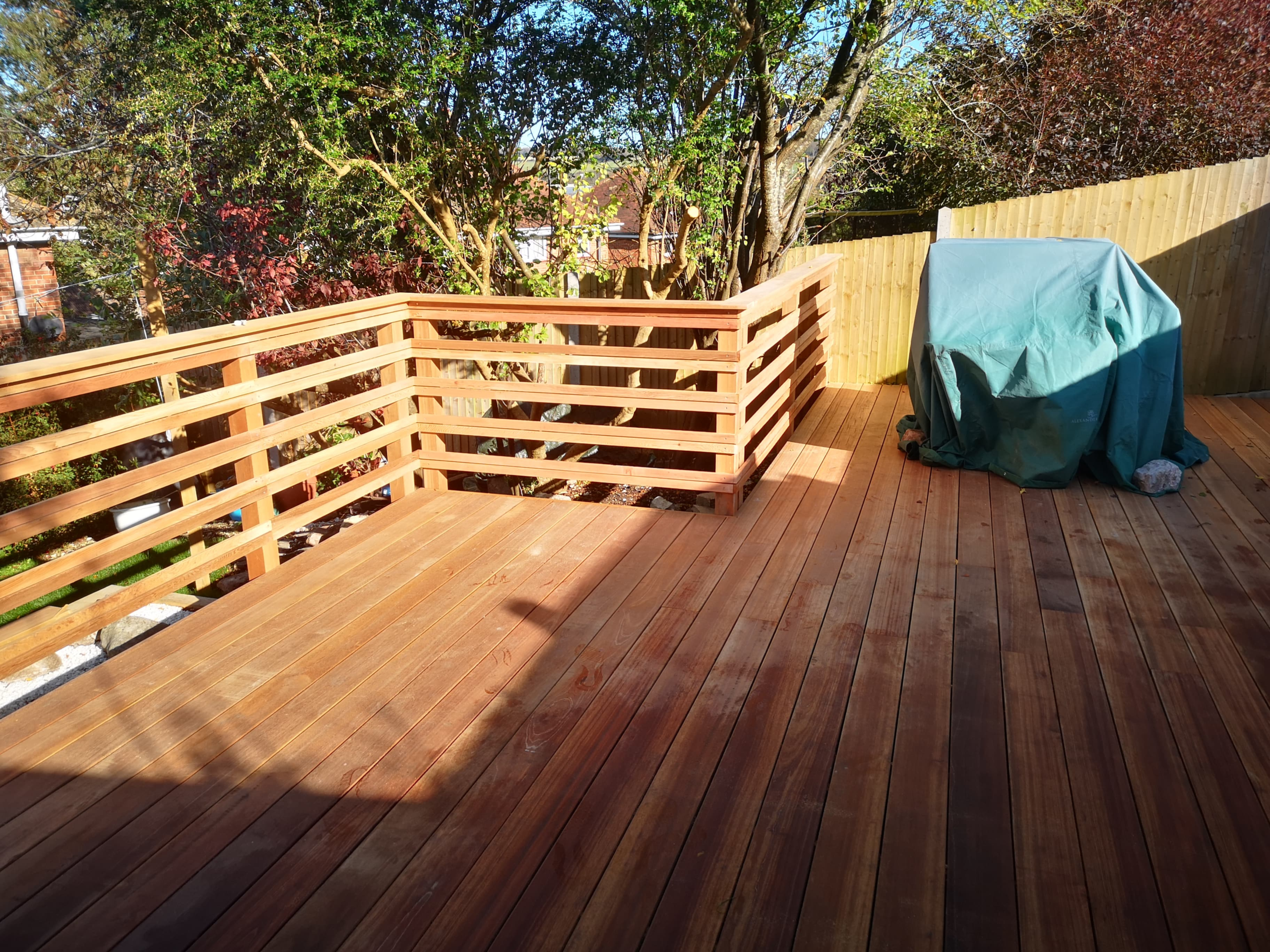 Timber decking with rails and seating by ARC Sussex Carpentry