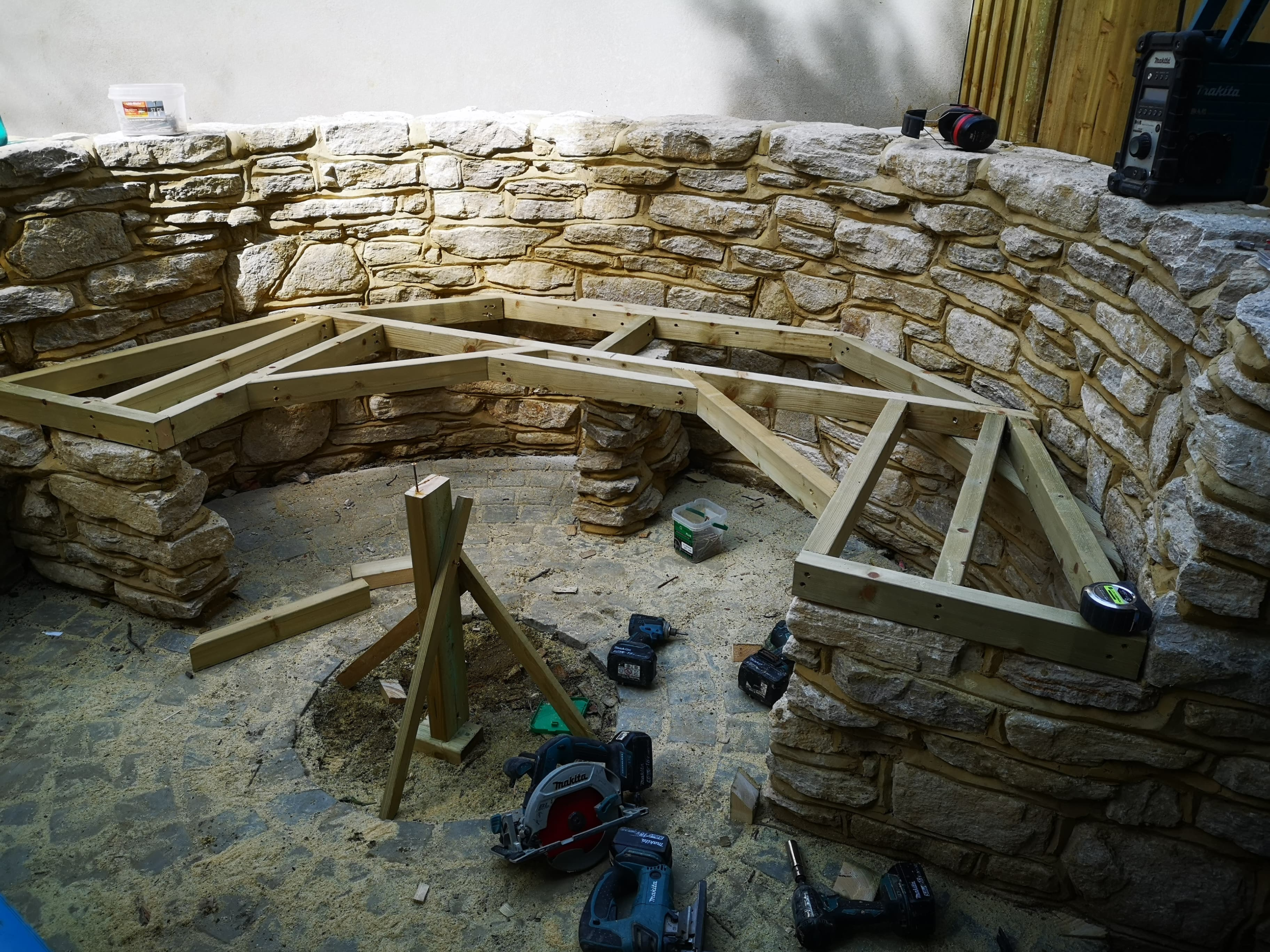 Timber framework being constructed for bespoke curved garden seating